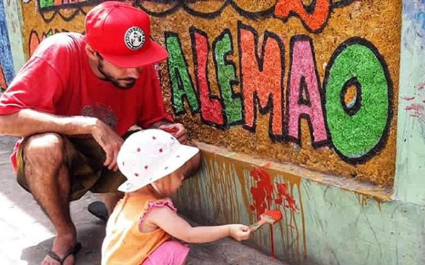 volunteer helping kids to paint