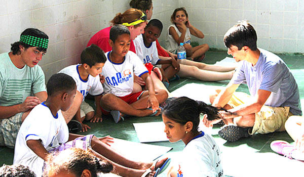 volunteer teaching orphan kids in orphanage