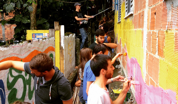 volunteers painting school wall