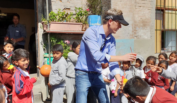 volunteer distributing drinks to students