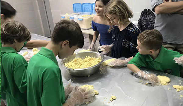 children preparing food for panda