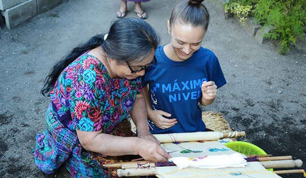 women telling volunteer about local products