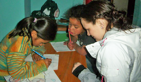 volunteer helping kids in teaching