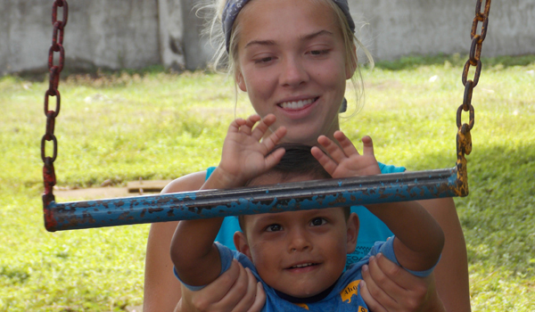 volunteer helping kids in playing