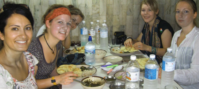 volunteers enjoying the food by host family