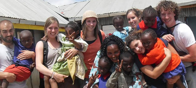 volunteers feeding a baby