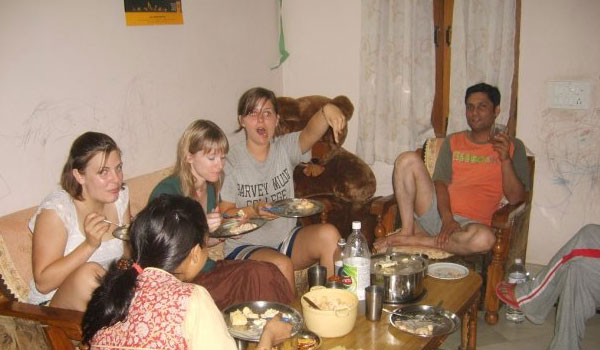 volunteers having meal with host family