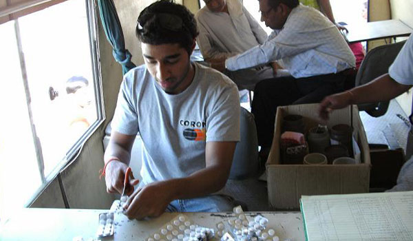 volunteer assisting in medicine packaging in india
