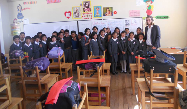 volunteer taking picture with school kids