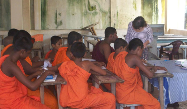 volunteer teaching buddhist monks in srilanka