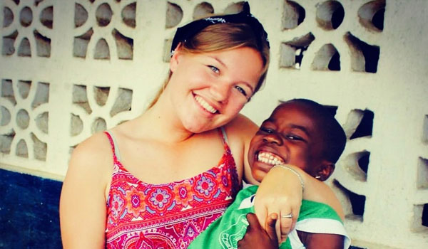 happy volunteer with happy kid tanzania
