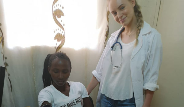 volunteer with medical patient in uganda