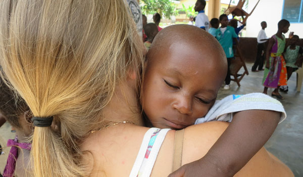 volunteer carrying child
