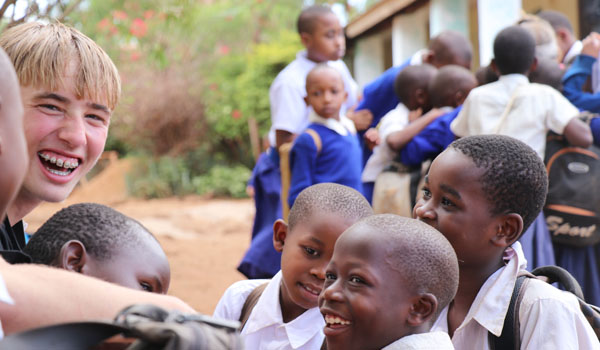 volunteer talking with school kids